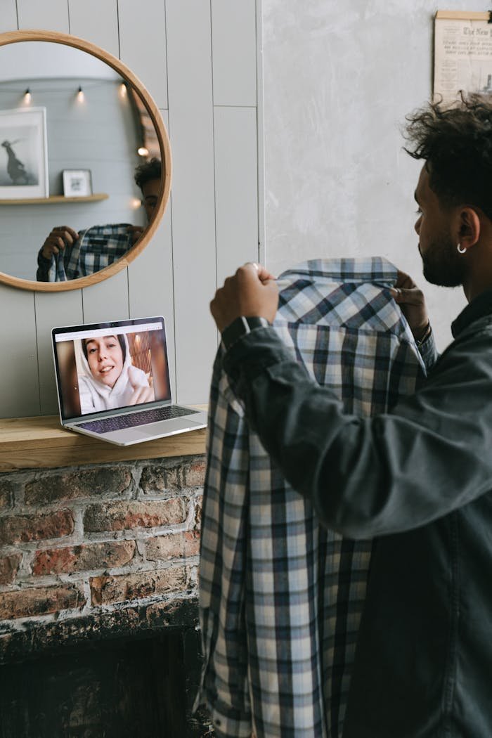 Person showing a shirt during a video call for online fashion advice.